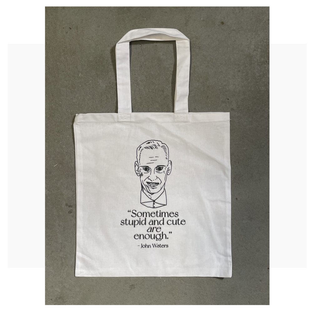Tote bag with a drawing of John Waters and his quote: Sometimes stupid and ugly are enough.