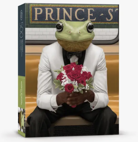 Frog Prince in a white tuxedo holding flowers Kiss Me 250 piece puzzle box.