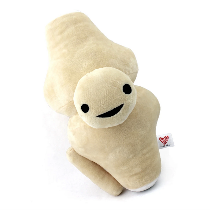 White knee joint plush with an embroirdered happy face.