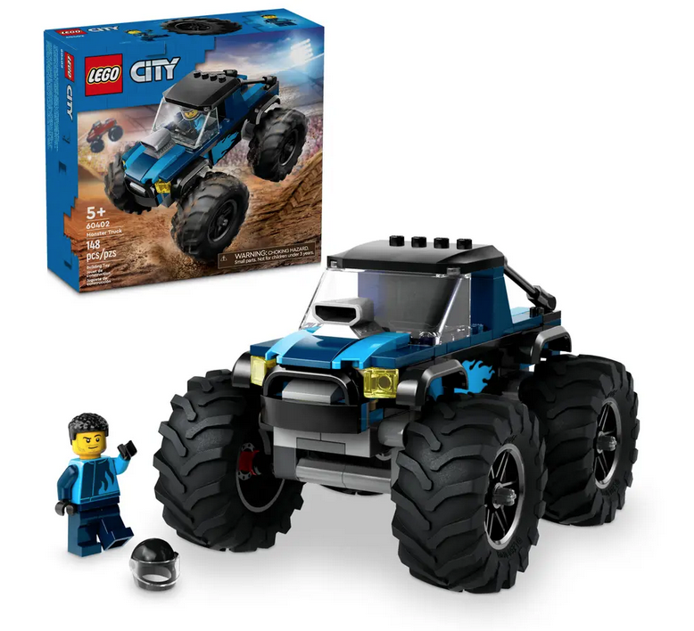 The Blue Monster Truck assembled with the driver standing beside it, the box is in the background. 