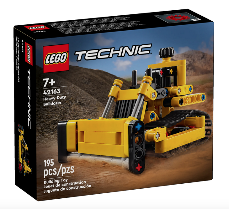 Box of LEGO Heavy Duty Bulldozer set. Features completed buldozer pushing dirt. 