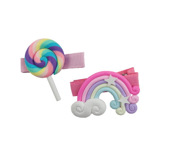 The hinged barrette clips are covered in grosgrain pink ribbon. One barette has a swirly lollipop in pink, purple, blue and yellow. The other has a cloud where the pink, purple, yellow and light blue rainbow begins. It ends in a flourish accompanied by a few stars along the way. 