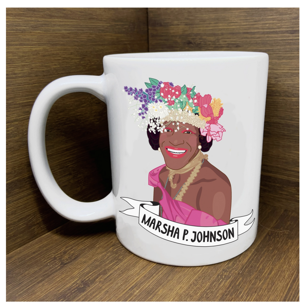 11 oz. white ceramic mug with original artwork of legendary Black Trans Activist, Marsha P. Johnson, wearing a crown of multiclored flowers gold jewelry and pink frock. 