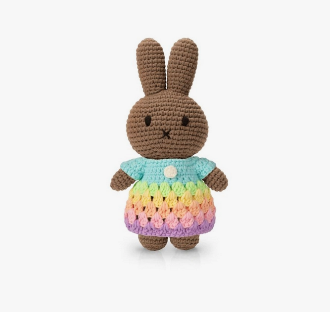 Melanie bunny crocheted doll wearing a pastel rainbow colored dress. 