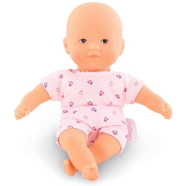 Mini Calin light skin doll in a pink one piece suit.