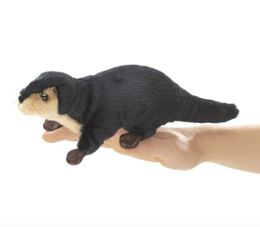 Dark brown with tan chest River Otter finger puppet on a hand. 