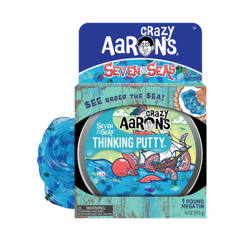 This tin of Seven Seas Thinking Putty with a depiction of a ship overtaken by a giant octopus on the high sea. You also get a glimpse of the Seven Seas Thinking Putty behind the package.  The putty is blue with sequins mixed in. 