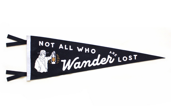 Black pennant with a person holding up a lantern and 'Not All Who Wander are Lost" in white.