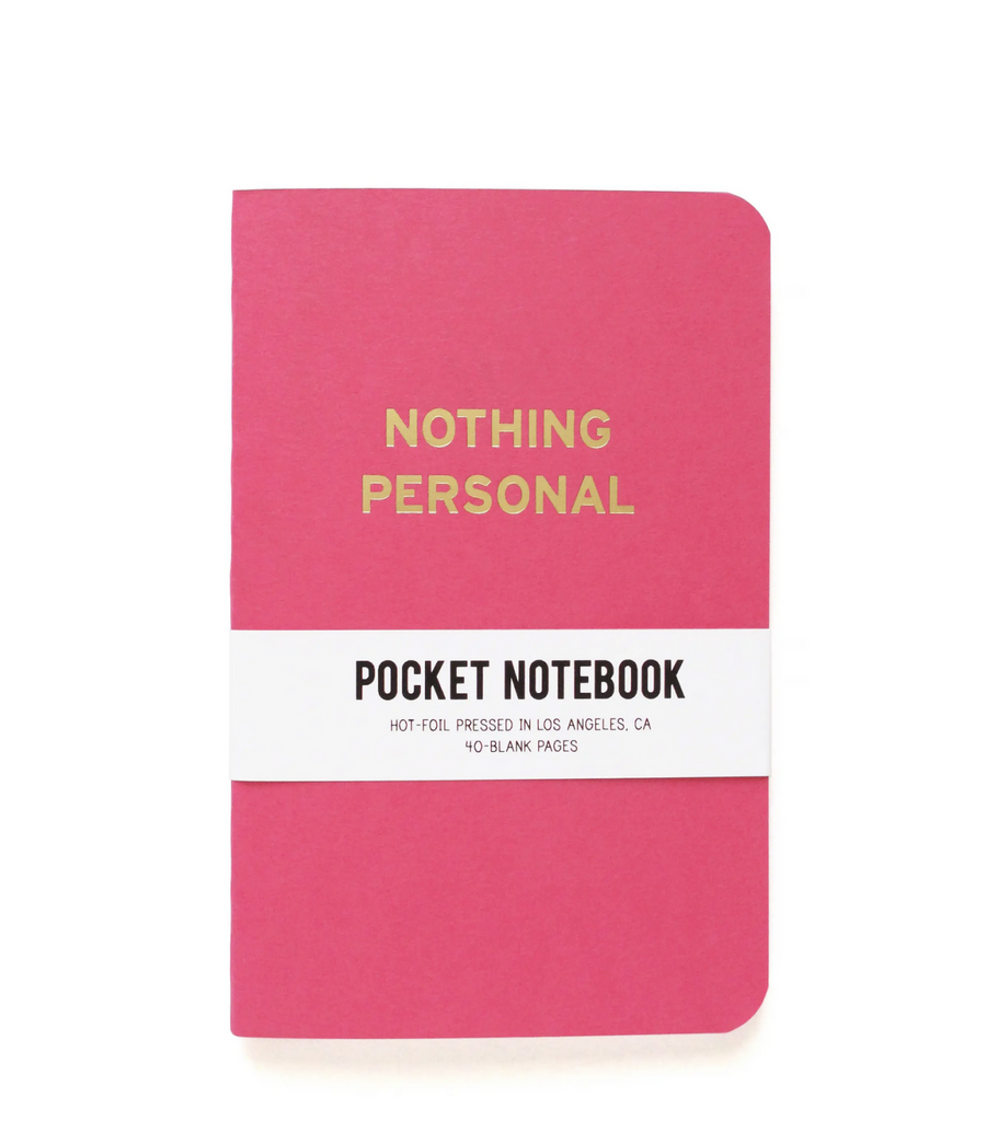 Pink pocket notebook reads Nothing Personal in gold.