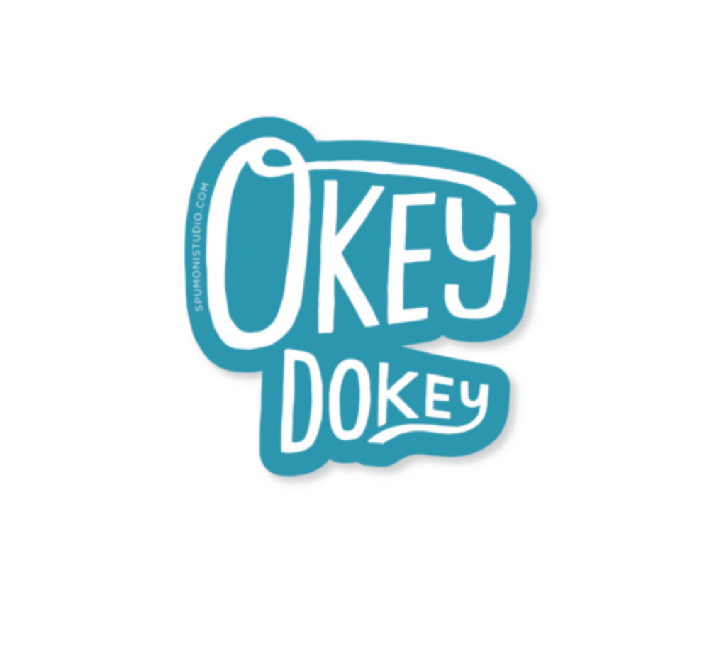Blue diecut sticker with white text reading "Okey Dokey."