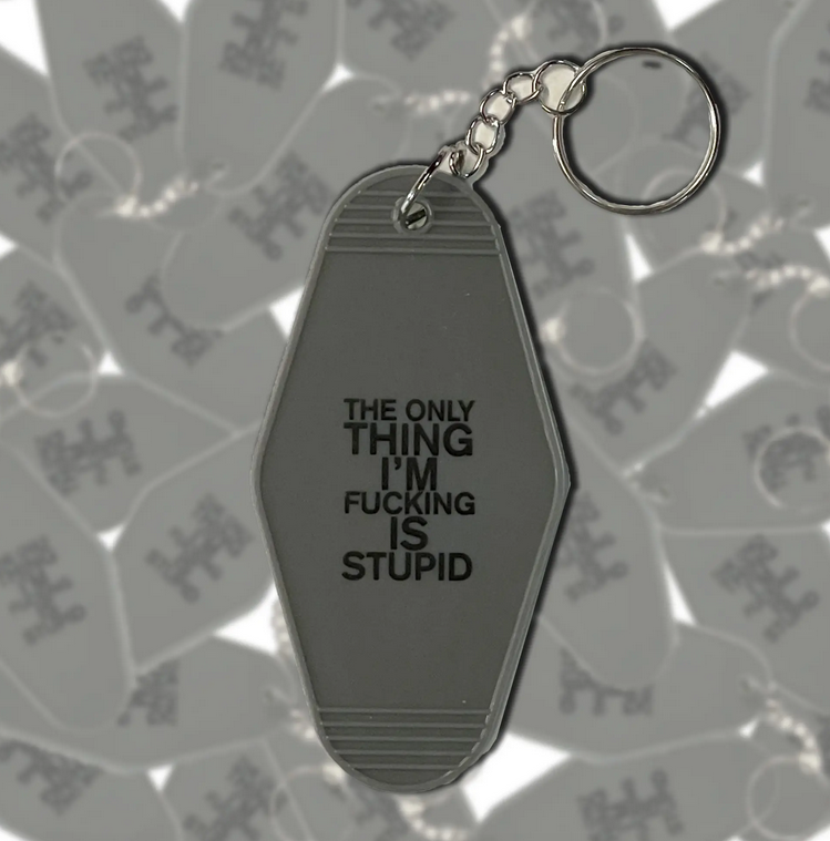 Gray motel style keychain that reads 'the only thing i'm fucking is stupid."