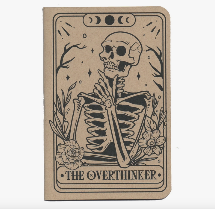 Cover ofOverthinker Tarot small notebook with "Oatmeal Speckle Tone" ans illustration of a skeleton thinking as if illustrated on a tarot card. 