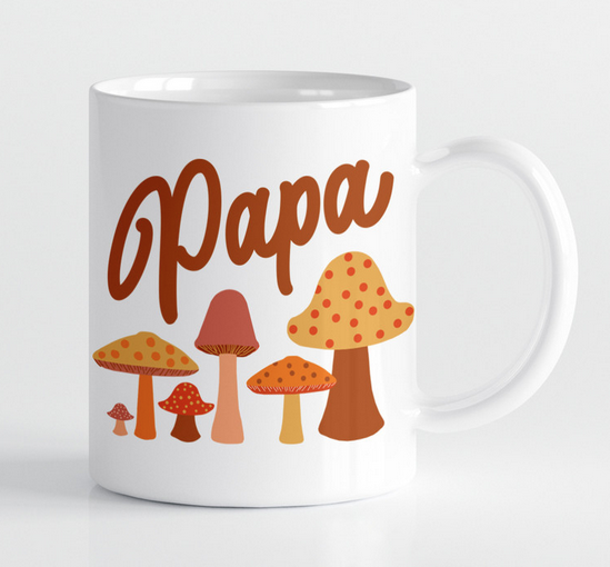 White ceramic mug with colorful mushroom graphics. 