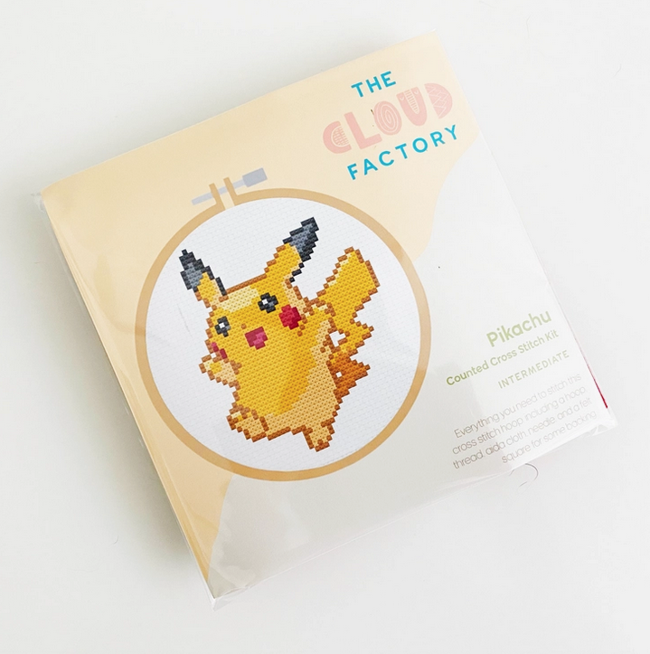 The Pikachu Cross Stitch kit in it's package with an illustration of the Pikachu  pattern. 