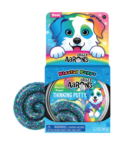 Playful Puppy Thinking Putty in roound tin. Displayed  in a cardboard header card with an adorable rainbow puppy waiting to play.  Clear putty with green, purple, and blue irregular shaped glitter pieces.