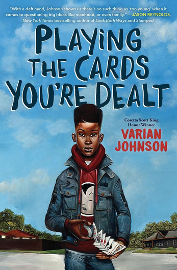 Cover of "Playing the Cards You're Dealt" by Varian Johnson shows a middleschool aged Black boy with a hightop fade wearing a red hoodie under a blue jean jacket and jeans shuffling a deck of cards.