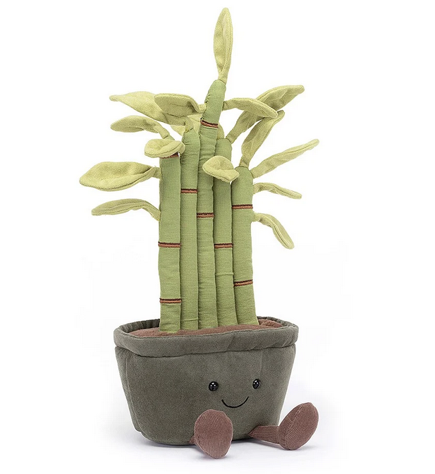 Plush potted bamboo plant with 5 stalks of varying height and leaf growth. Potted in a brown pot with a smiling face and brown couduroy boots. 