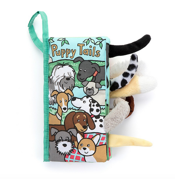  The Puppy Tails Activity Book is full of sights, sounds and wags! This bright cloth book has crinkle panels, colourful pictures and lots of fluffy tails! Hang the loop on the buggy for giggles during walkies! 