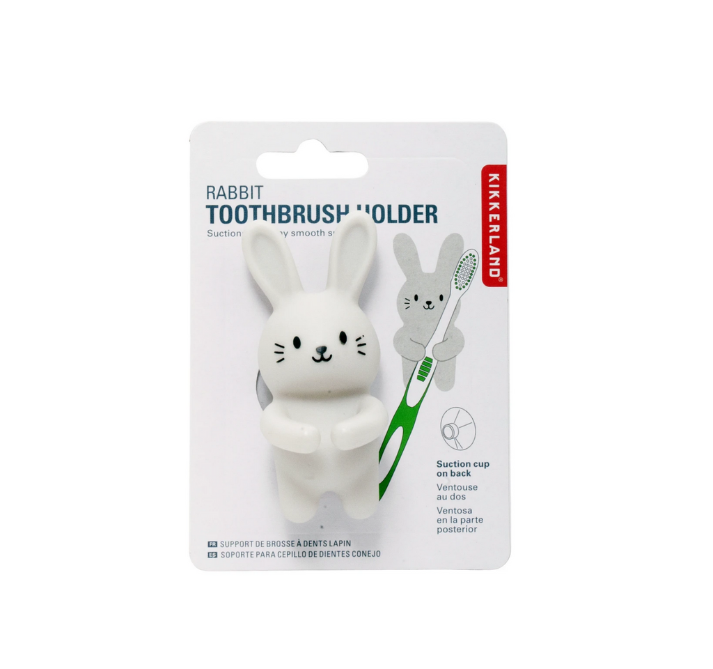 White silicone rabbit with it's arms circled to hold a toothbrush on a white hangcard. 