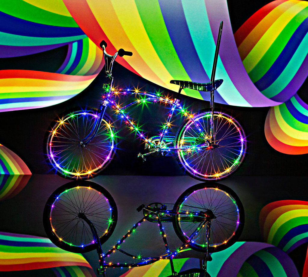 Bike with Rainbow Brightz bike lights lit up in a dark space.