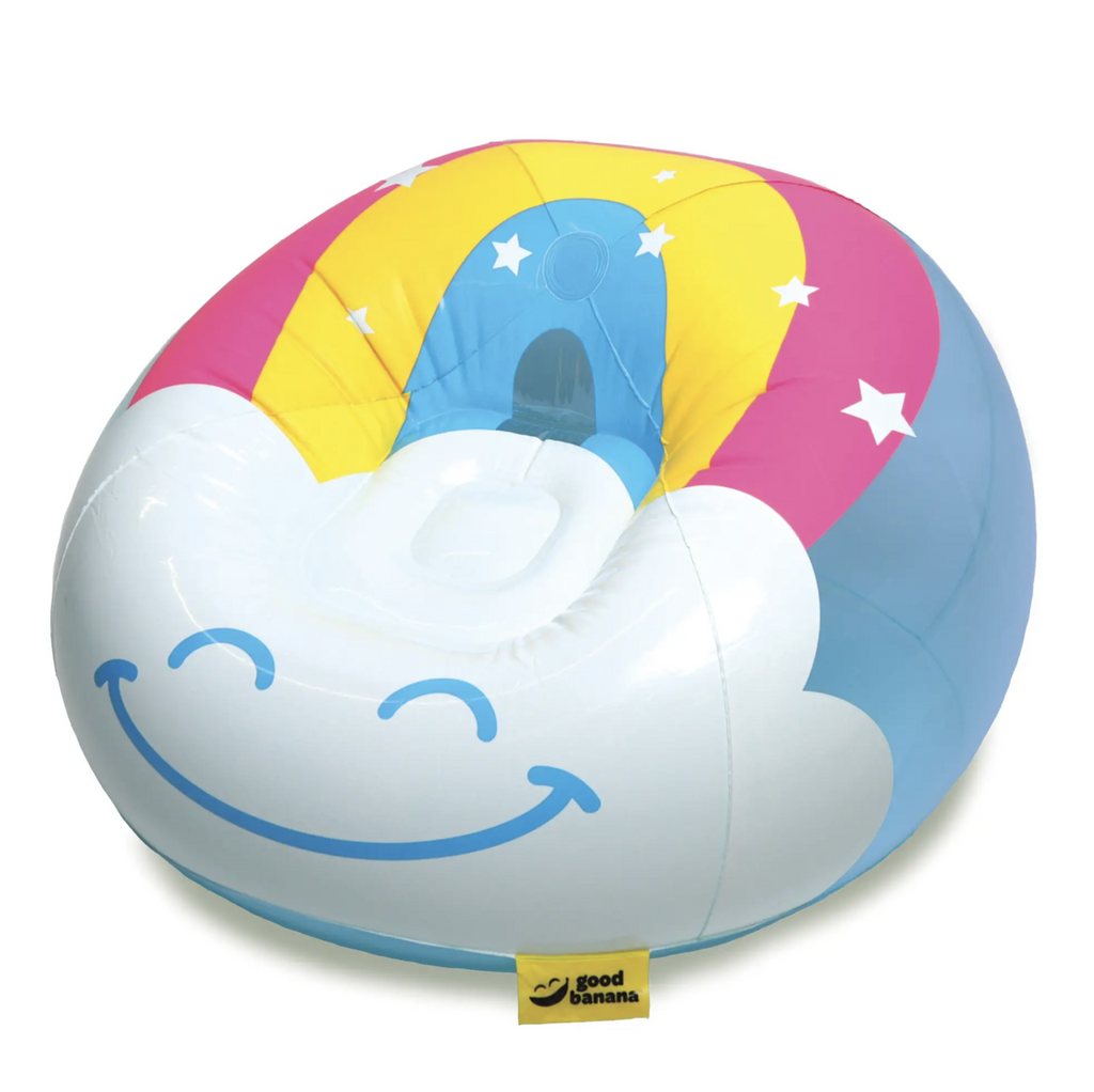 Inflated rainbow comfy chair has a happy cloud in the front and blue sky with rainbow on the back.