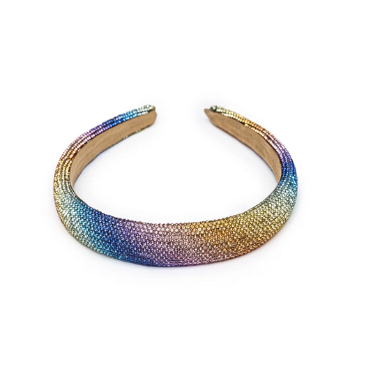 The Rainbow Sparkle Headband is completely wrapped in rainbow sparkles. There is an ombre effect from one side to the other with colors ranging from yellow, blue, green, purple and pink.