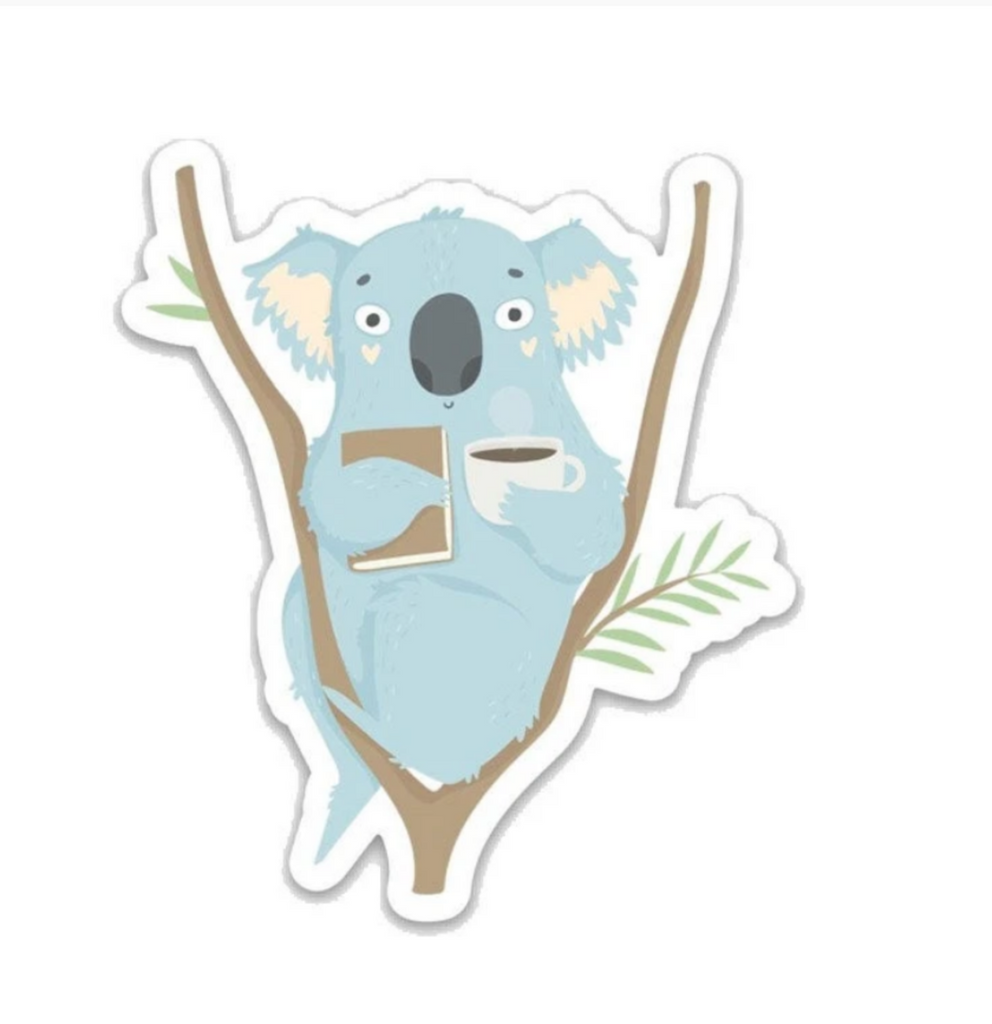 Diecut sticker of a happy blue koala sitting in branches, holding a coffee mug and book.