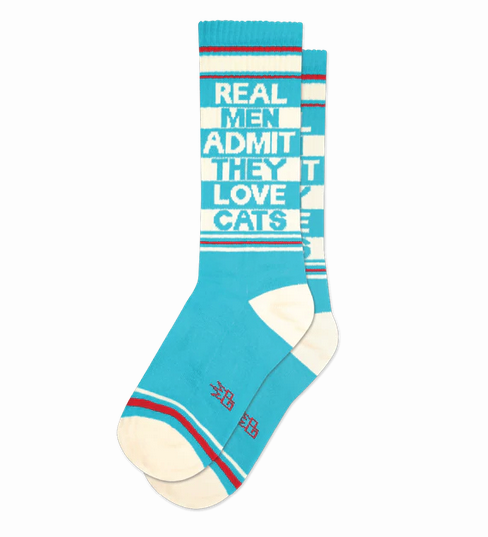 These super-comfy, unisex, one-size-fits-most, gym socks are made in the USA of cotton in a bright blue, off white and red color scheme. They read Real Men Admit They Love Cats. 