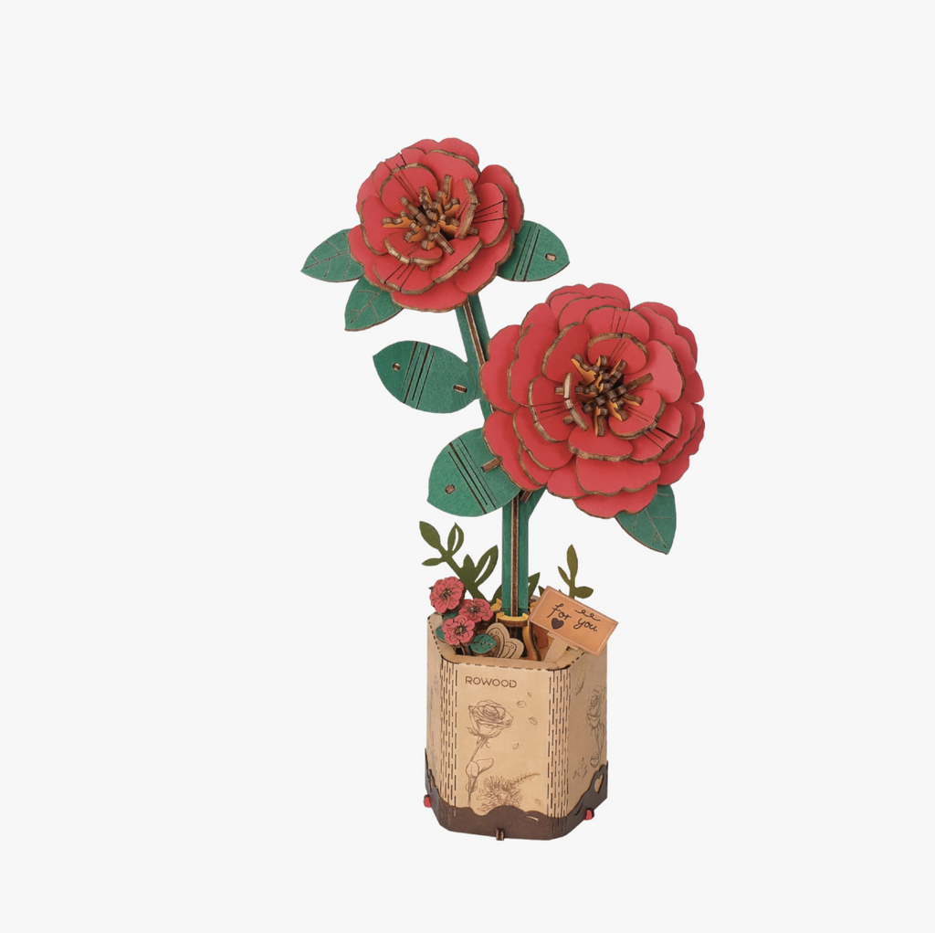 Assembled red camellia DIY wooden flower puzzle on cardboard base.