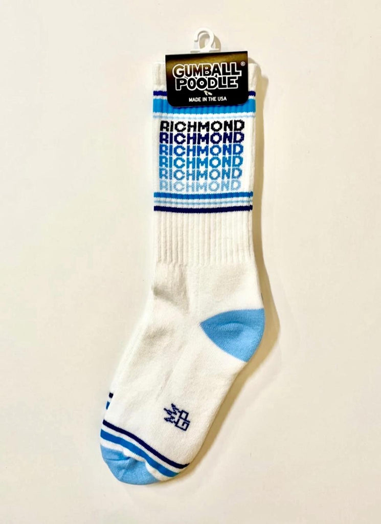 White athletic socks that read RICHMOND in repeating blue colors.