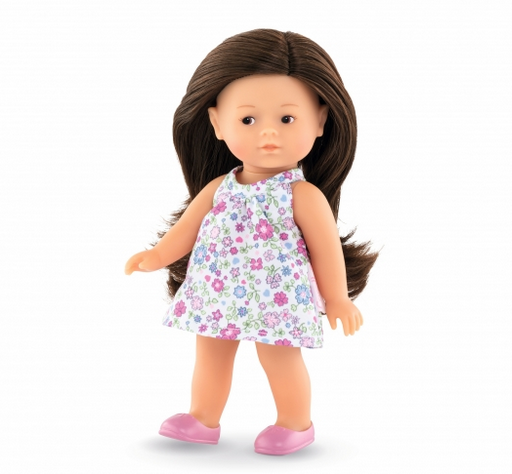 Romi mini corolline doll. Light skin with long brown hair in a white floral dress.