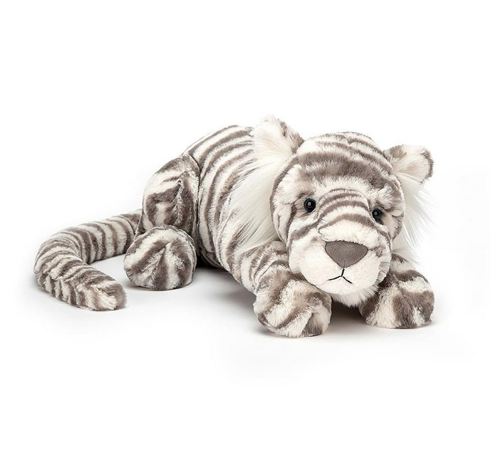 Plush Snow Tiger laying on it's tummy with grey and white striped fur. 