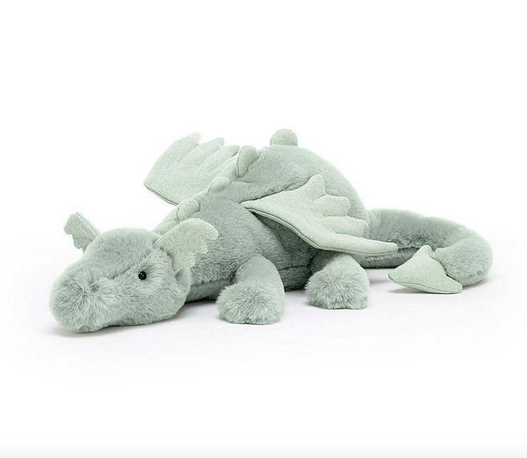 Sage green plush dragon viewed from the side. It's head resting on th efloor and his tail wrapped around it's side. 