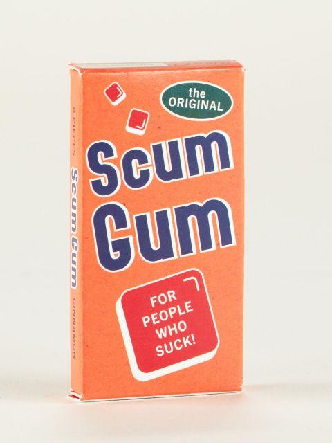 Bright orange box of gum with "the original" in a green bubble, and Scum Gum in large blue block letters, and a red square bubble that reads "For People Who Suck" in white letters. 