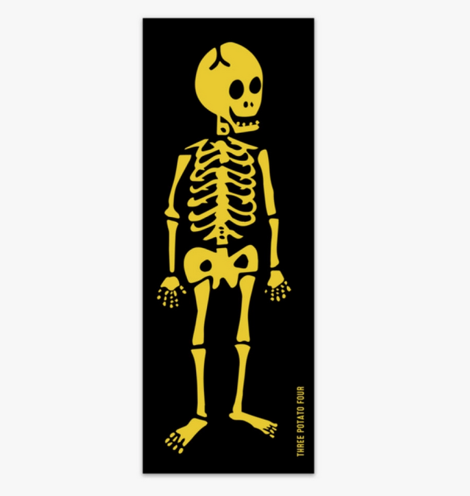 Vertical rectangle magnet with a yellow skeleton on a black background.