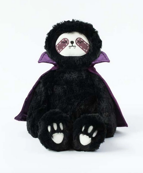 Vlad Kin sititng up right with black fur and violet cape. 
