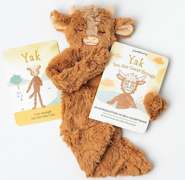 Slumberkins Yak Snuggler, board book, and affirmation card. The Yak snuggler is a reassuring lovey for children with soft fur that’s perfect for snuggles. The board book with an introduction to self acceptance and a card with a daily affirmation for your child to practice and carry with them wherever they go.