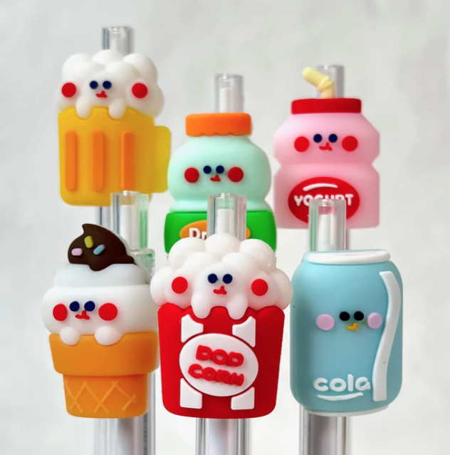 Retractable gel pens with cute fast food and snack toppers. With soft serve ice cream, a box of popcorn, can of cola, mug of beer, yougurt carton, and milk bottle. 