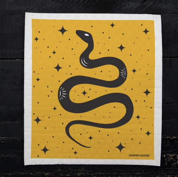 Square dishcloth with yellow background and a swirly black snake printed on it. 