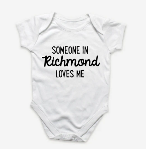 White baby onesie with black lettering. Reads "Someone in Richmond Loves Me". 