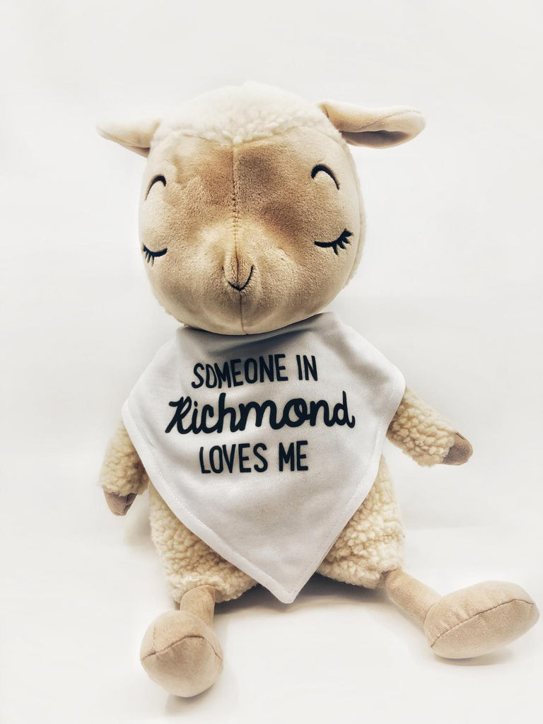 Lamb plush wearing a Someone in Richmond Loves Me bib.