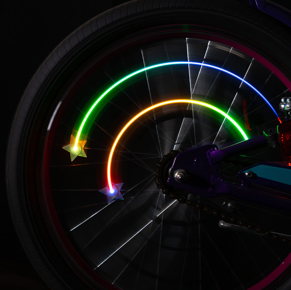 Starbrightz bike spoke lights on a bike wheel in motion.