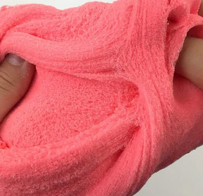 Strawberry Sour Patch sensory play slime being stretched. 