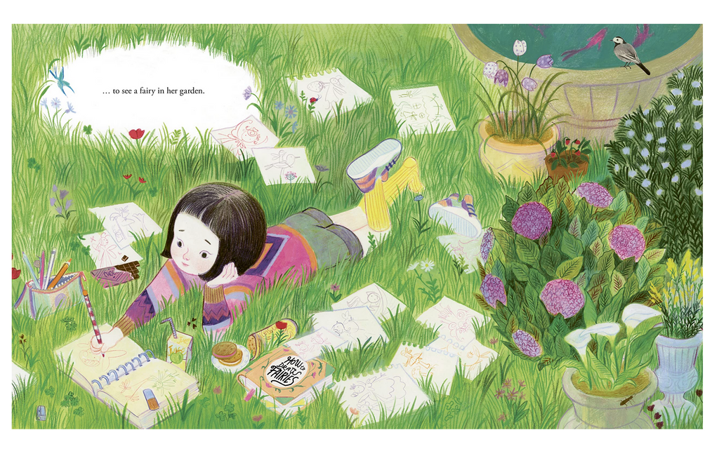 Book page of young girl laying in grass drawing in a notebook.