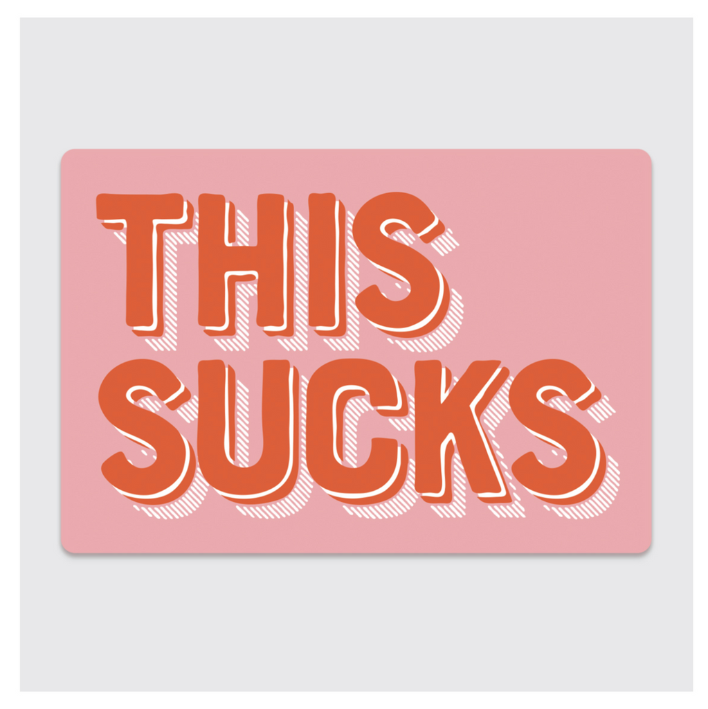 Pink rectangle sticker with red text that reads "This Sucks."