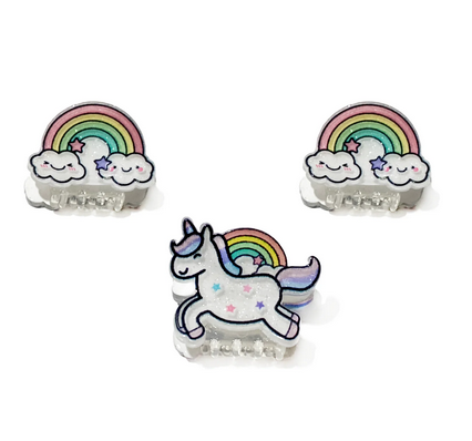 Mini claw clips with unicorns, rainbows and clouds. Set of three,  one with a white unicorn with colorful stars and a purple pink and blue mane and tail with a rainbow bursting out behind it. The other two clips a, rainbow begins and ends with a cloud with smiling happy faces. 