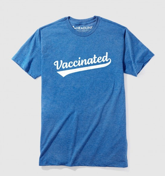 Blue tshirt reads Vaccinated in white.