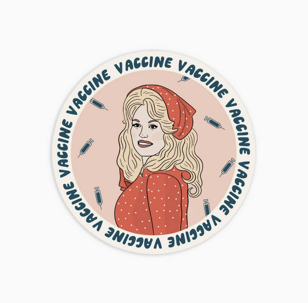 Round sticker with Dolly parton in a red polkadot shirt and head scarf. Text around the edge reads Vaccine, Vaccine, Vaccine!
