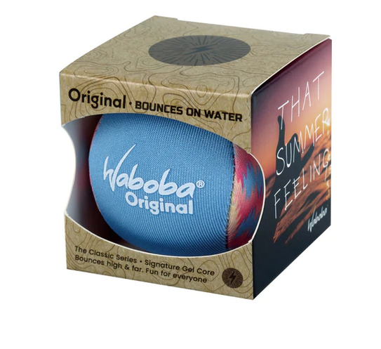 High performance water bouncing ball. This particular Waboba is packaged in a cardboard box that is open at the front. The ball is blue with a colorful pattern in yellows, orange, and blue. 