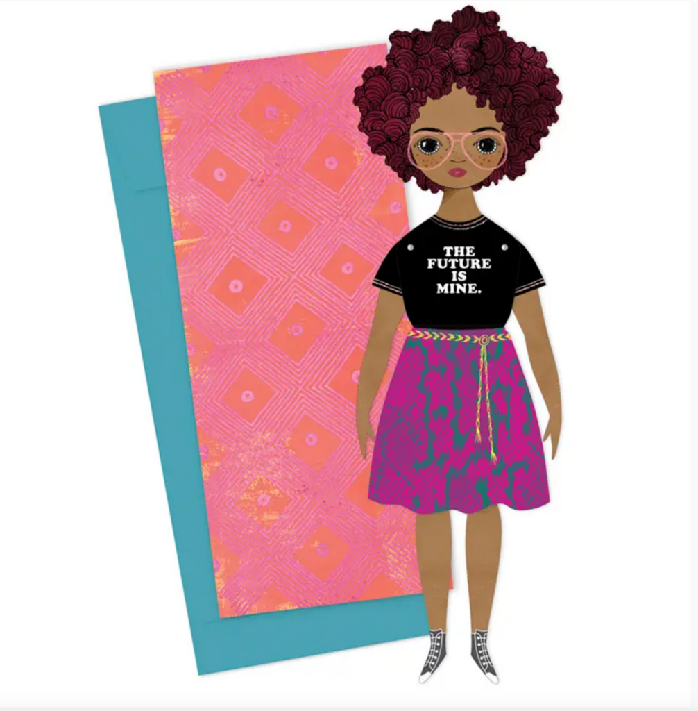 Card and paper doll with envelope. Paper doll is a Black women with burgundy curly hair, pink glasses, freckles, wearing a pink snakeskin skirt, black sneakers, and a black t-shirt that reads "The Future is Mine."